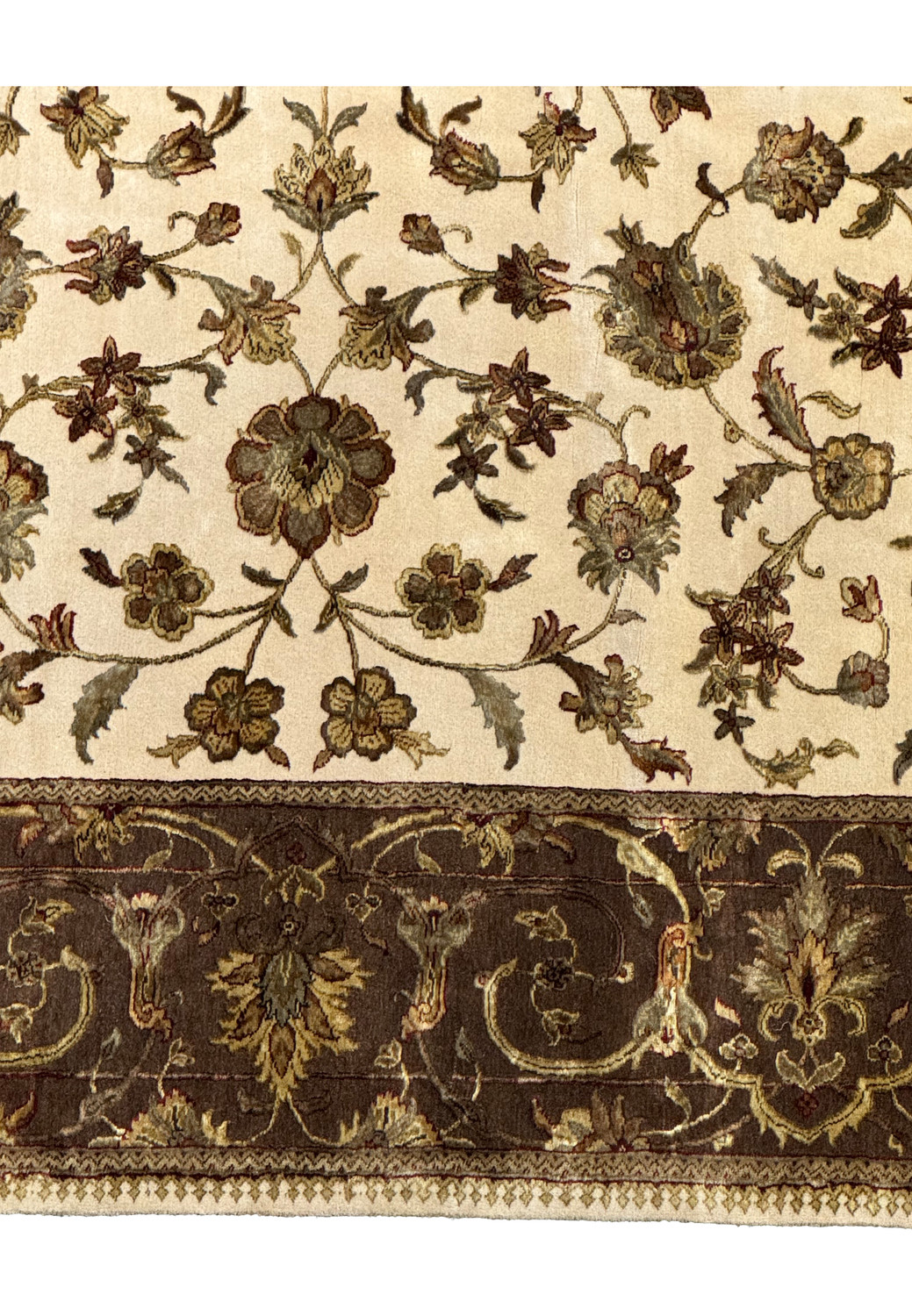 A detailed view of the Chobi rug's central field with a dense floral pattern in earthy tones of brown, green, and burgundy on a creamy beige base.