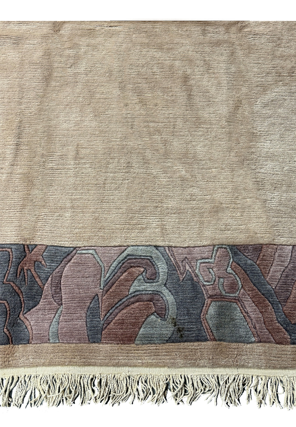 Close-up view of the Modern Royal Tibetan rug's border pattern and color details.