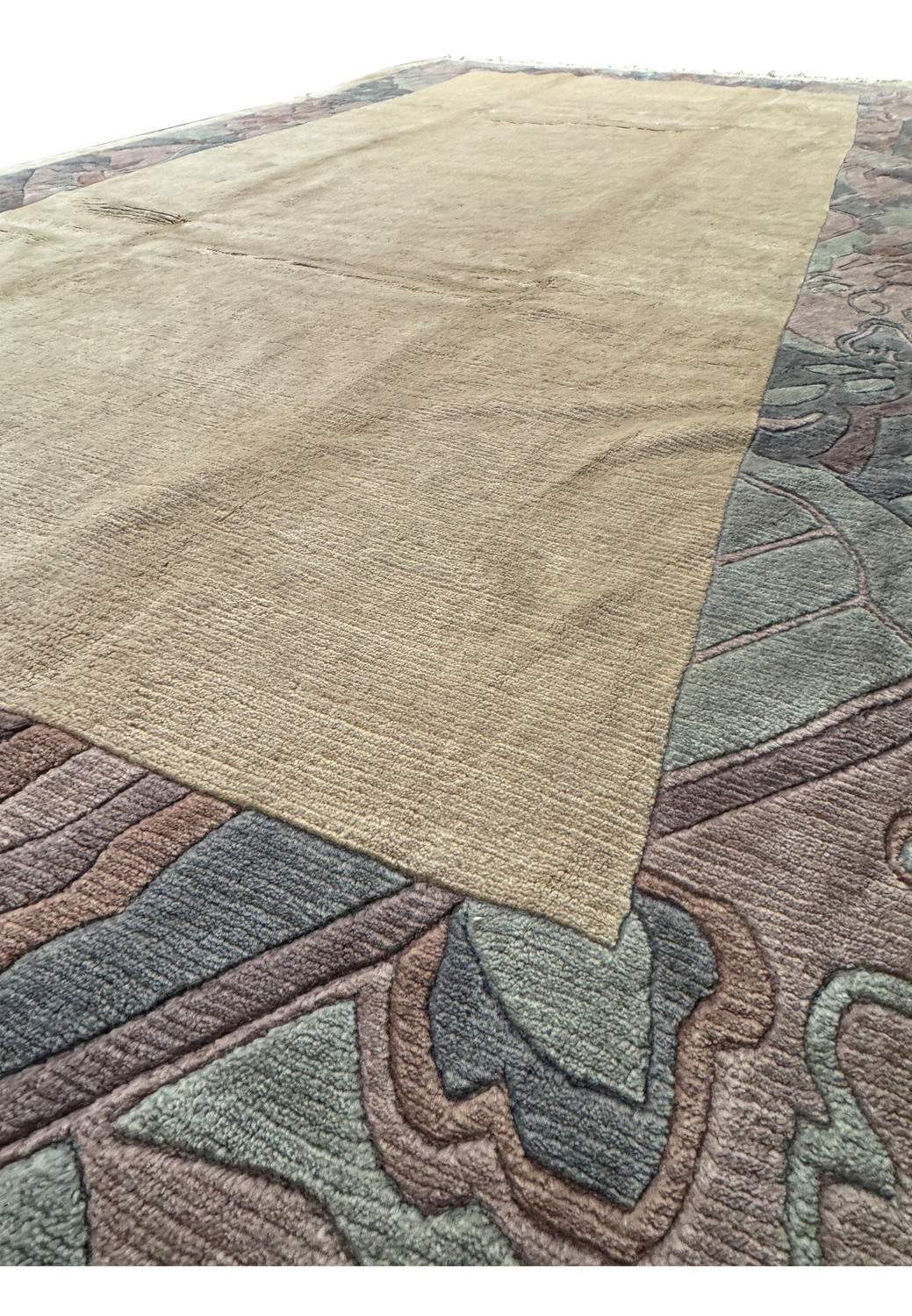 Mid-section view of a Modern Royal Tibetan beige rug showing the border and central field