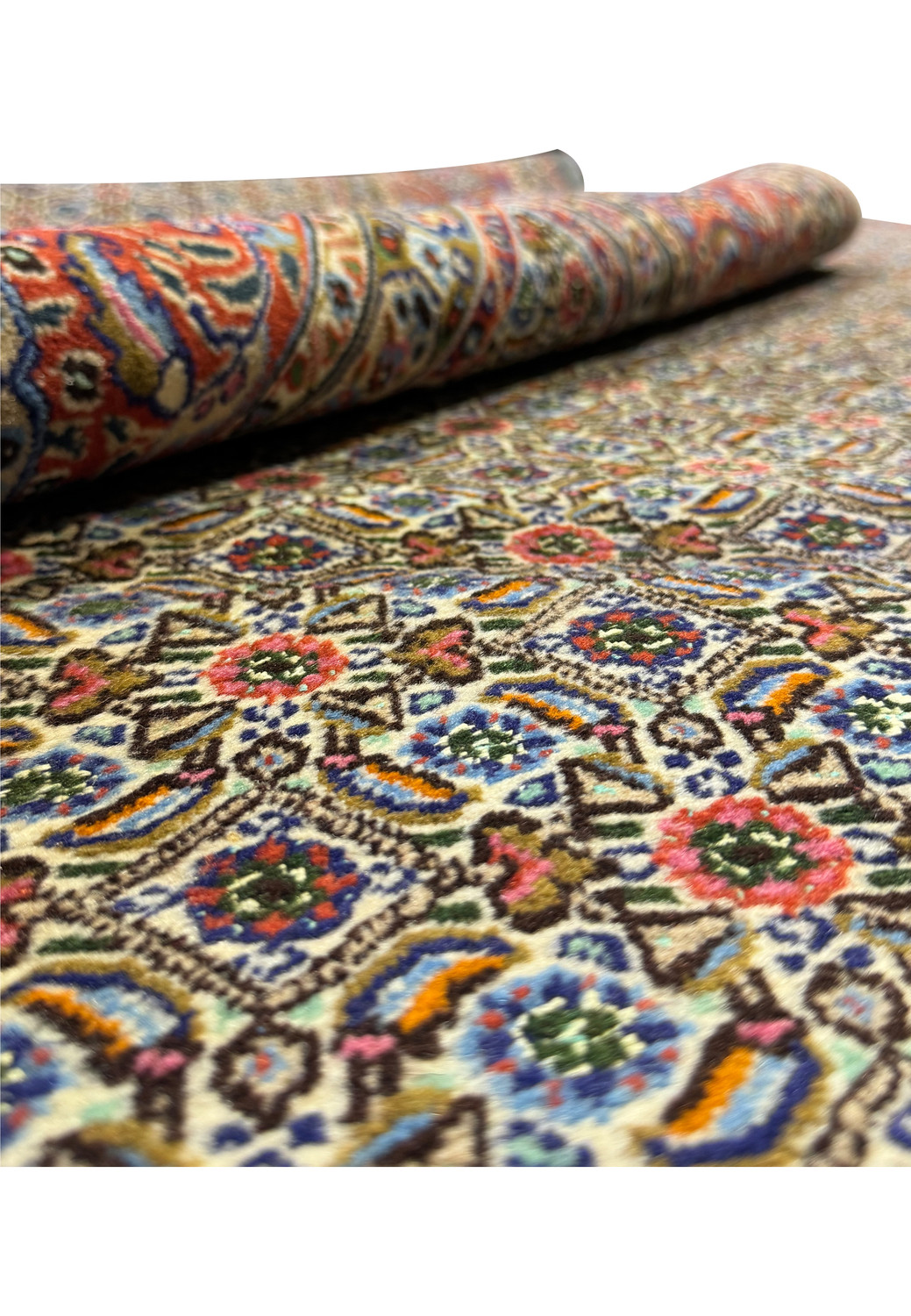 An angled view of the Persian Moud Rug, partially rolled to show the depth of the pile and the intricate design, with a focus on the lush floral and geometric patterns