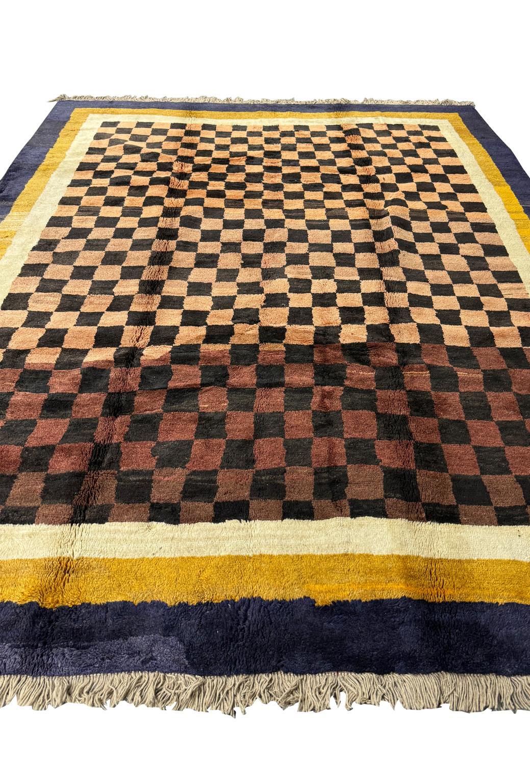 Angled perspective of the modern Nepal rug, emphasizing the bold checkerboard design and contrasting indigo and golden yellow border.