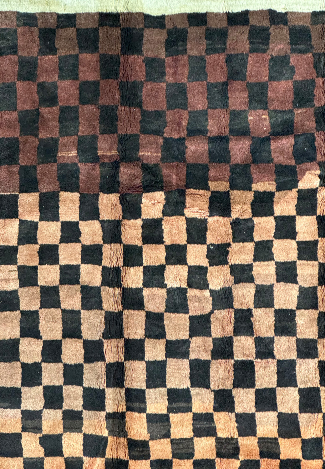 Close-up of the Nepal rug showcasing the intricate weave and color variations in the checkerboard design with brown and beige squares.