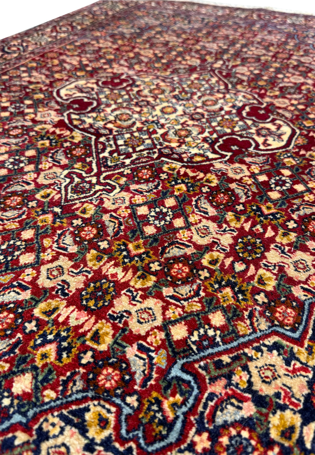 Close-up angle showing the dense weave and vivid colors of the floral and geometric motifs on a 3 x 4'7" Persian Bidjar rug