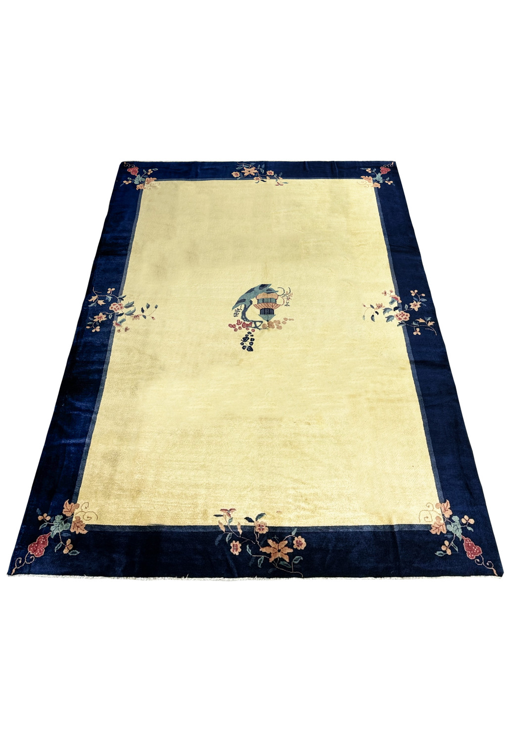 Full view of a pristine 10 x 14 vintage Art Deco rug laid out flat, showcasing the contrast between the navy border and beige center with decorative elements