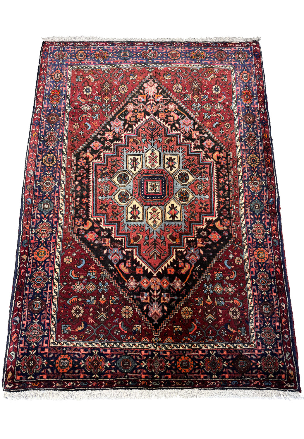 A full-view image of a traditional Persian Gholtogh rug laid flat, highlighting its symmetrical design and the detailed borders that frame the central motif.