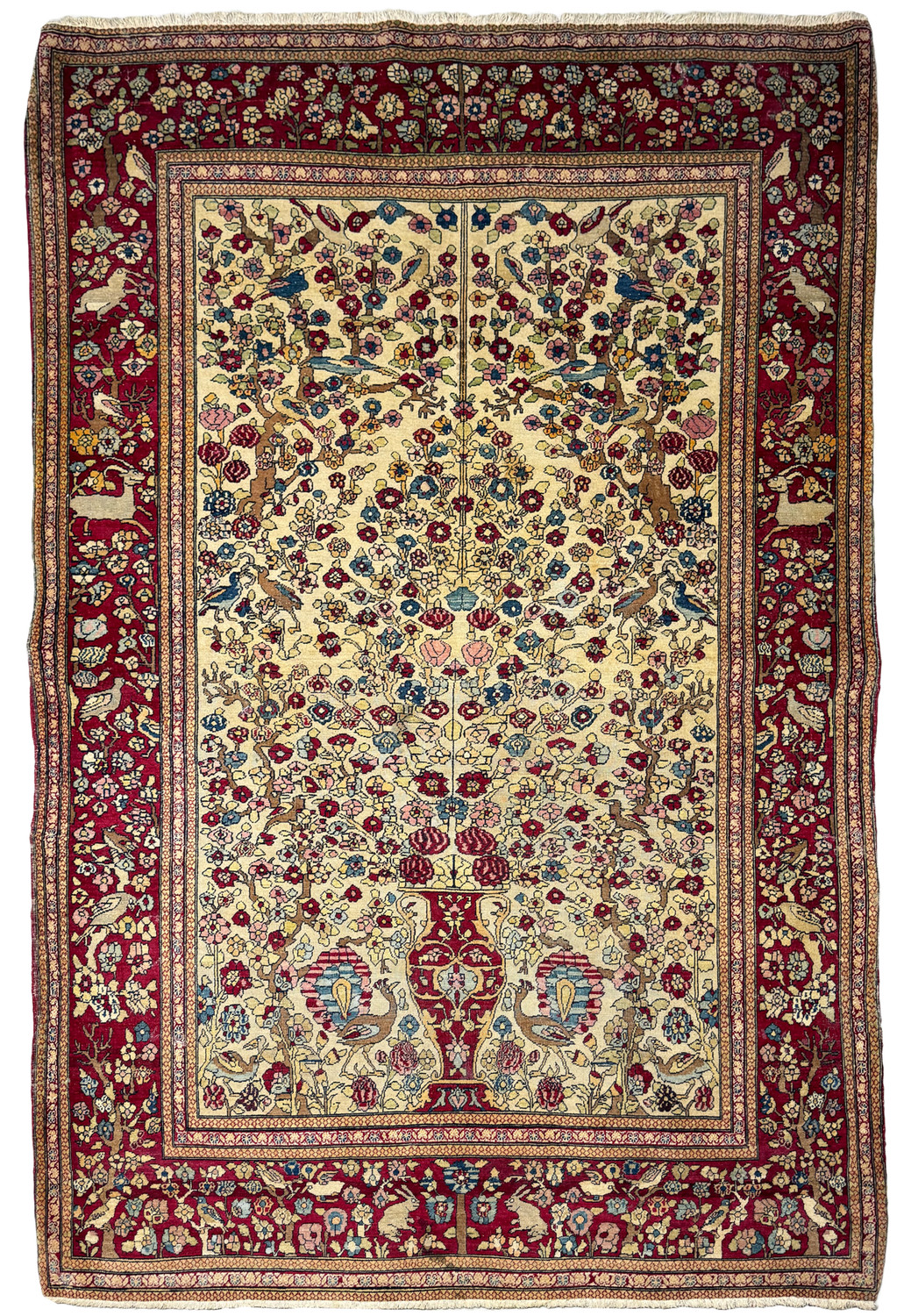 An intricate Antique Persian Farahan rug displayed in full view, showcasing its rich burgundy borders and a diverse floral pattern against an ivory background.