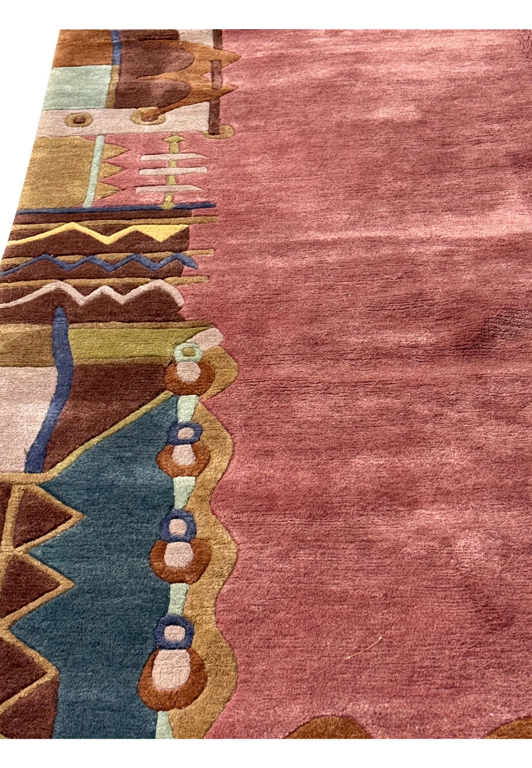 Handcrafted modern Tibet rug with rose center and multicolored geometric border.