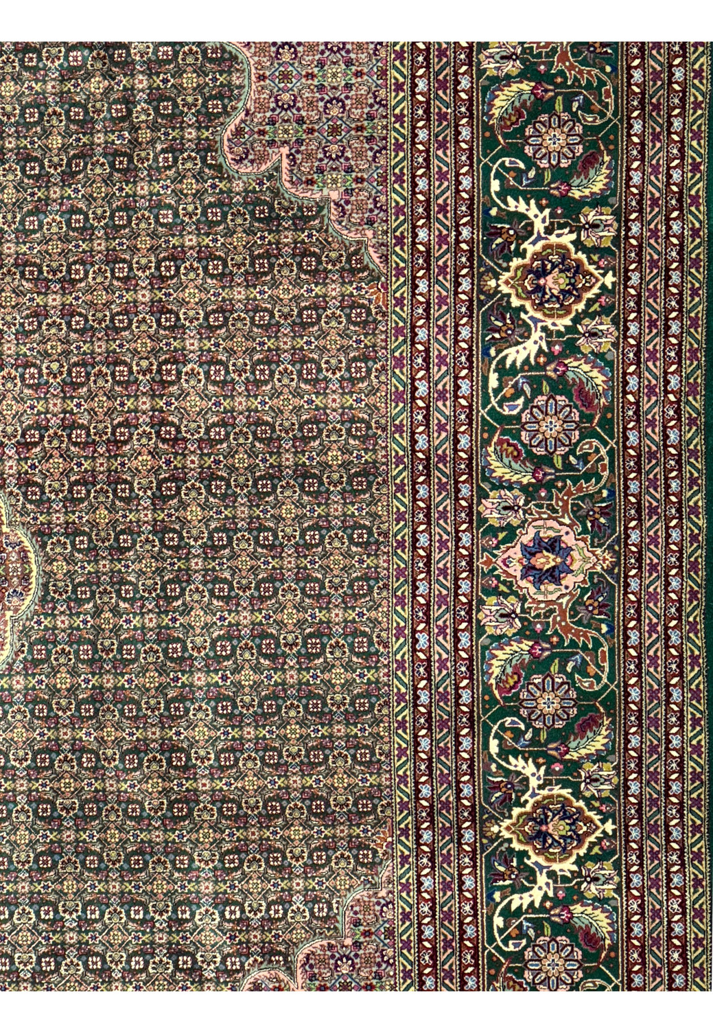 Detailed floral patterns and fish motifs on a Persian Tabriz 50 Raj rug.
