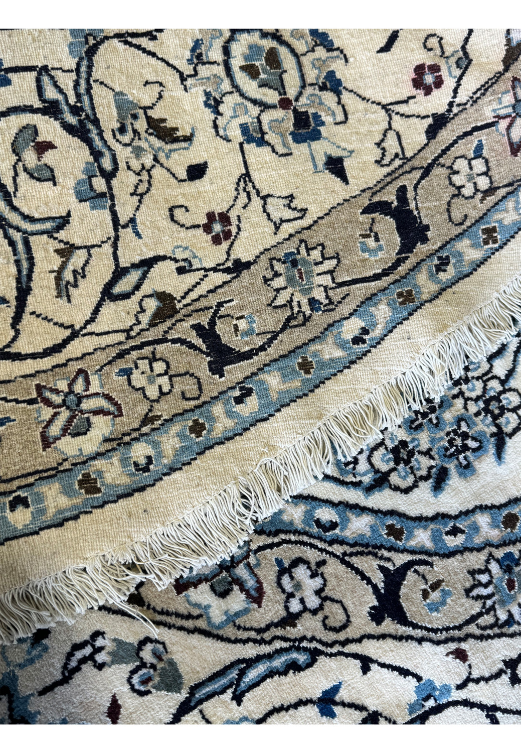 Macro shot of the handwoven knots on the back of the Persian Nain Round Rug, illustrating the rug's exceptional weave technique.