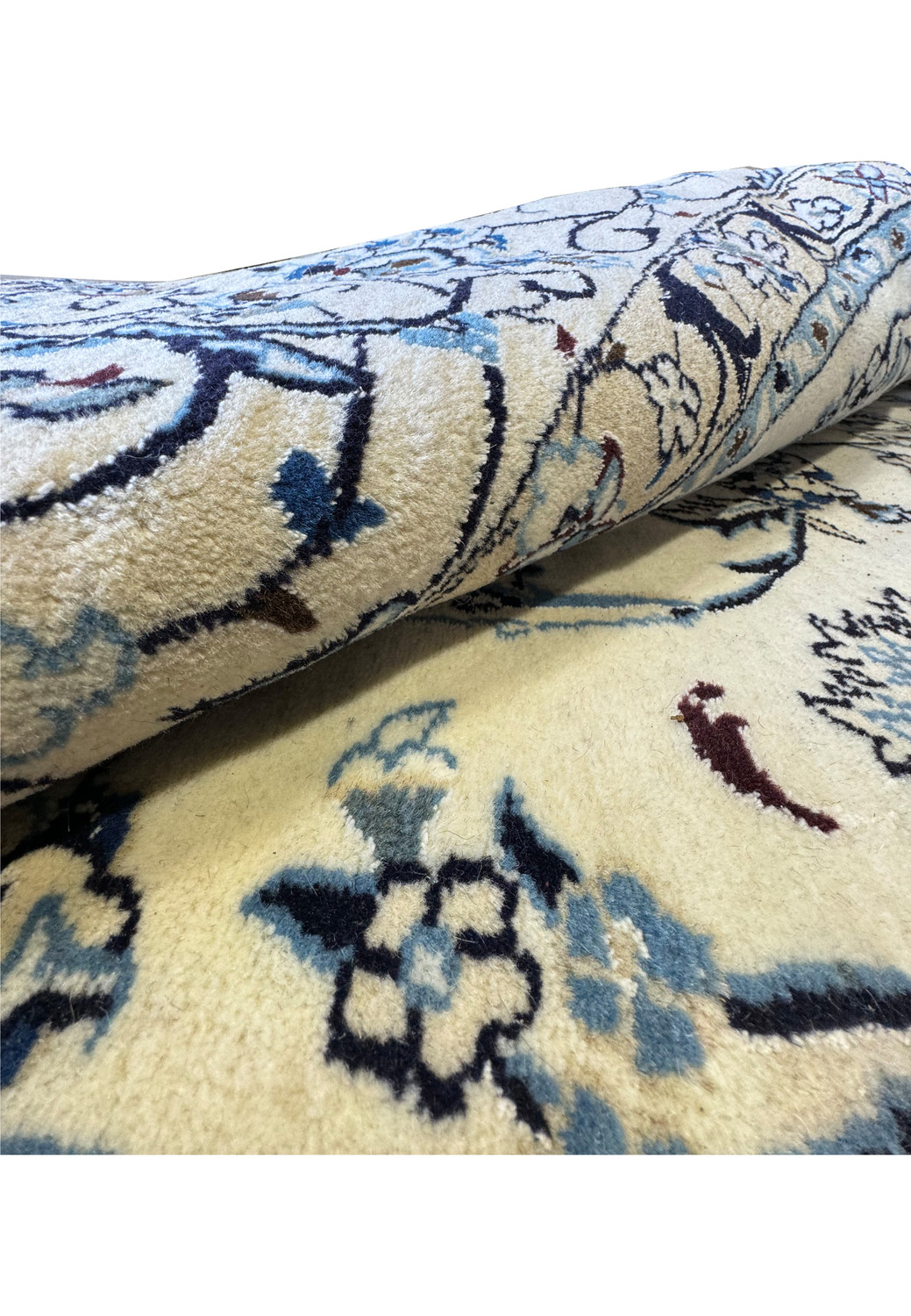 Close-up of the delicate floral patterns and rich blue accents on the Persian Nain Round Rug.