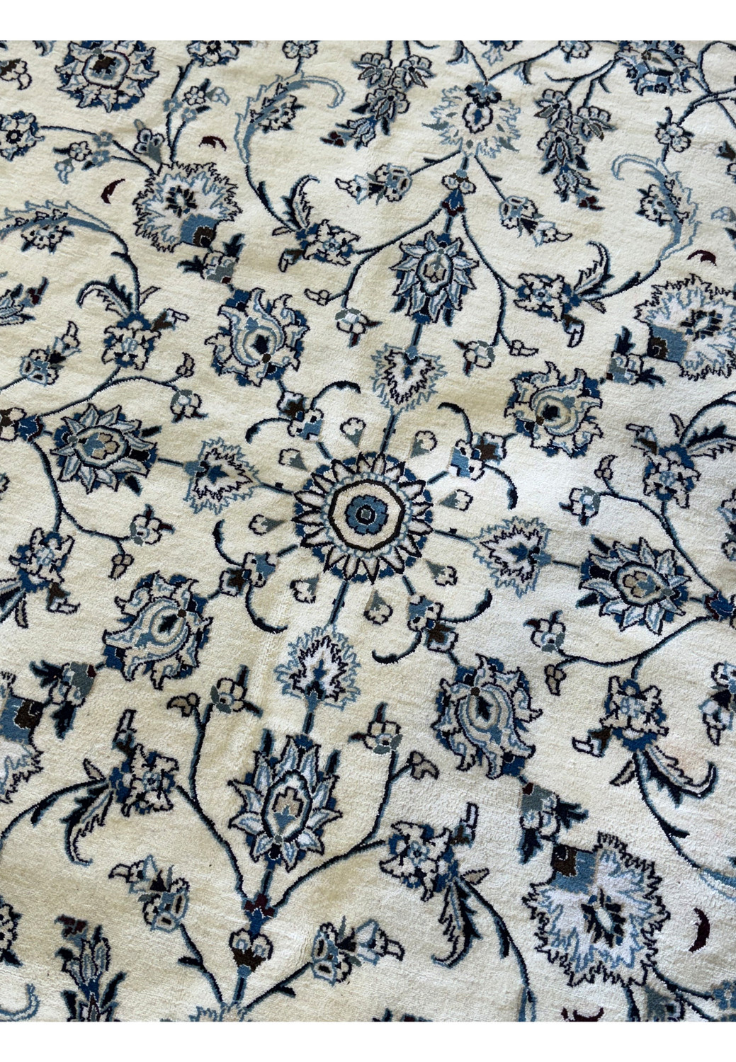 Artisan-crafted Persian Nain rug with elegant border detailing