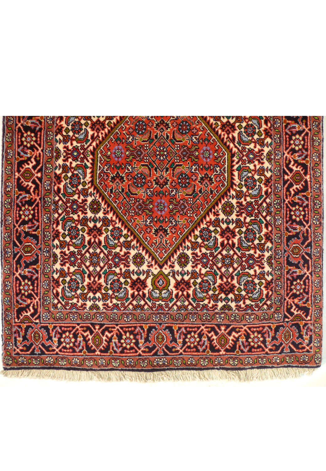 Detailed close-up of the central design of a Persian Bijar Runner Rug, featuring symmetric medallions and a complex interplay of colors