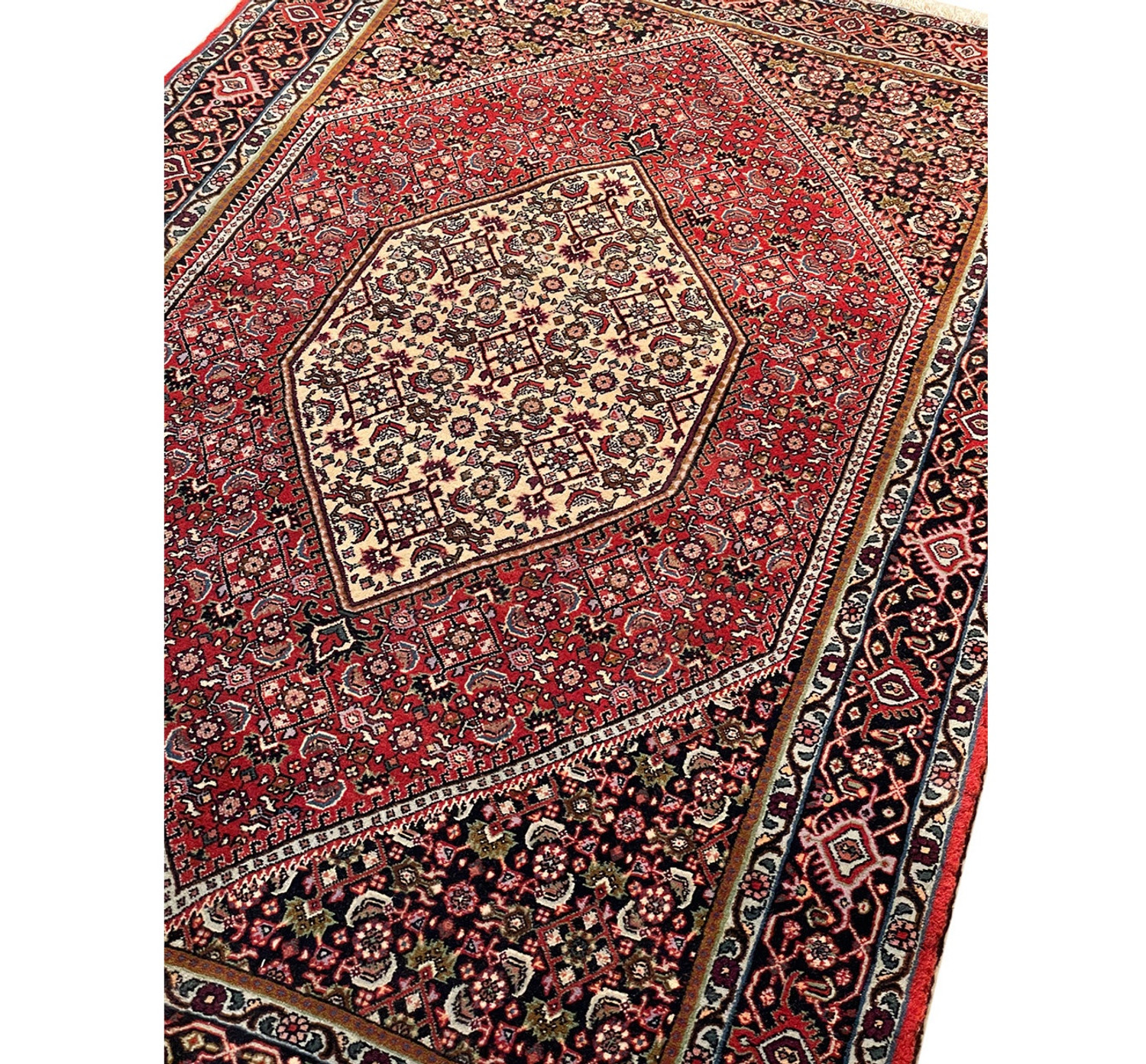 Angled view of a Persian Bijar rug, highlighting the plush pile and detailed motifs