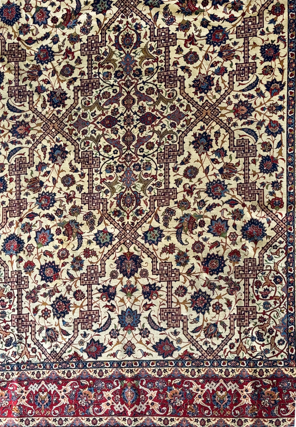 Close-up of the rug's central design and part of the main border, emphasizing the detailed motifs and vibrant colors.