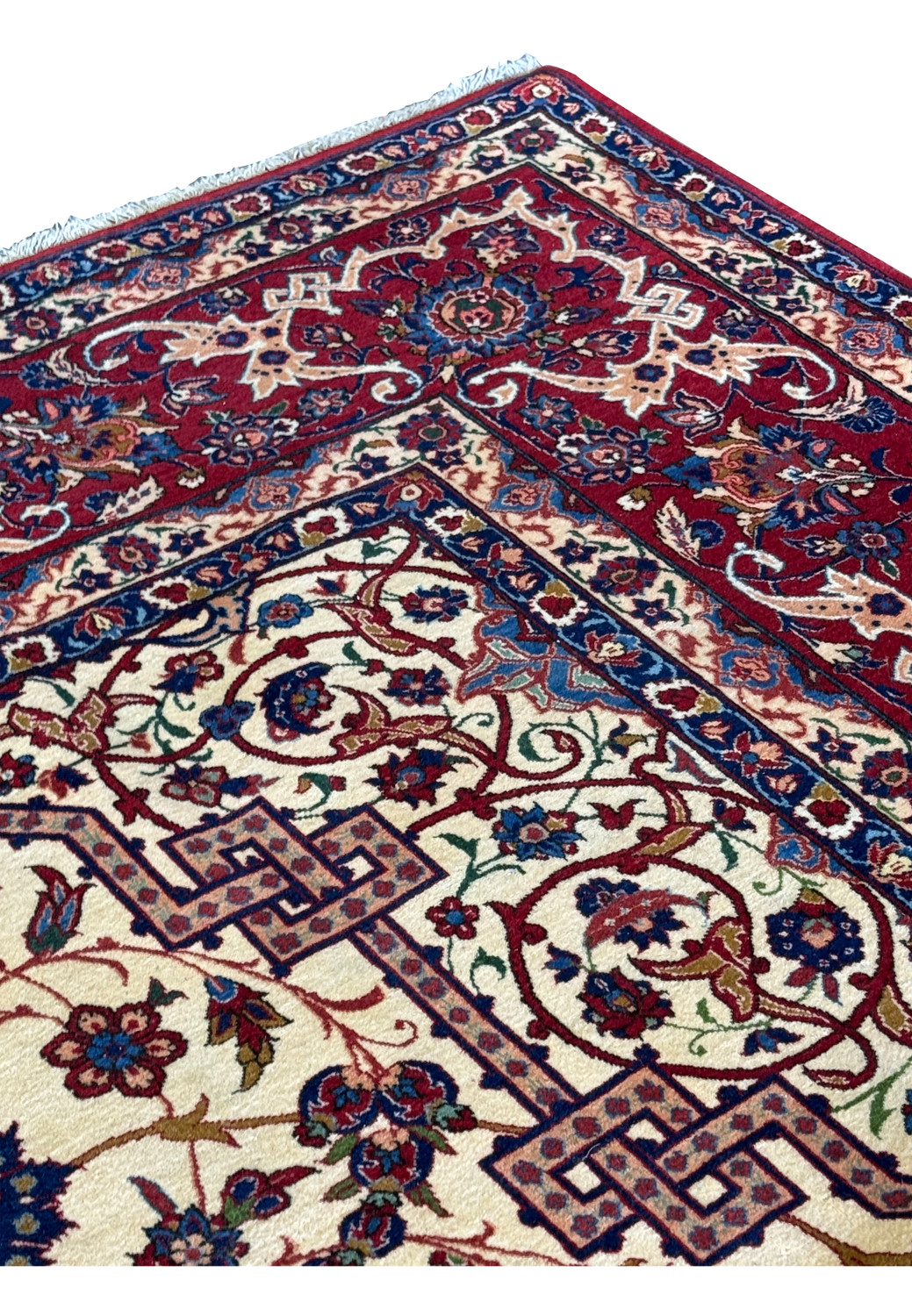Side view of a 10'7 x 14'7 Persian Isfahan Wool & Silk Rug, showing the depth of the pile and the richness of the red border and ivory field.