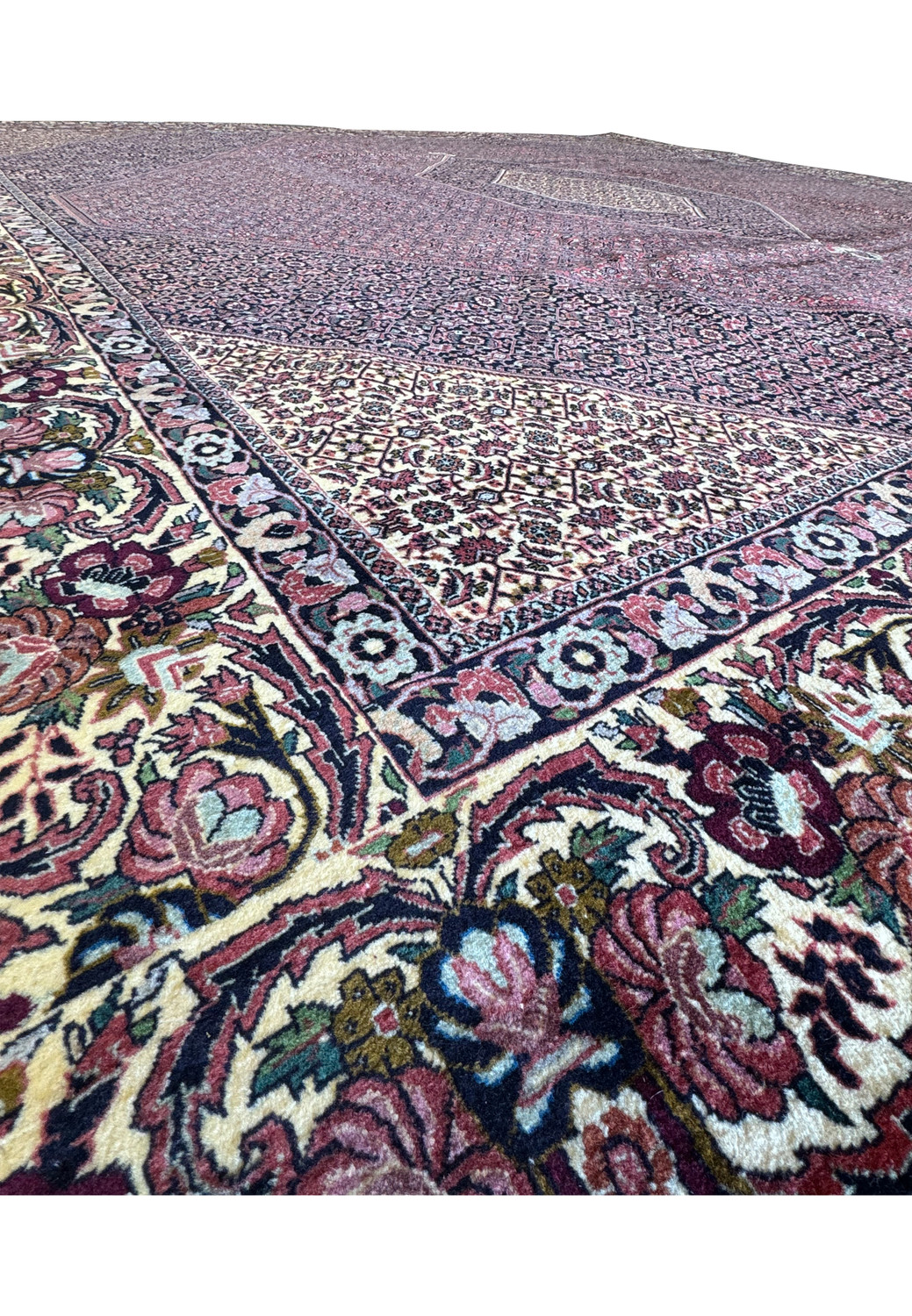 An angled side view of the rug, revealing the full expanse of this remarkable piece, providing a comprehensive view of its intricate patterns and harmonious color palette.