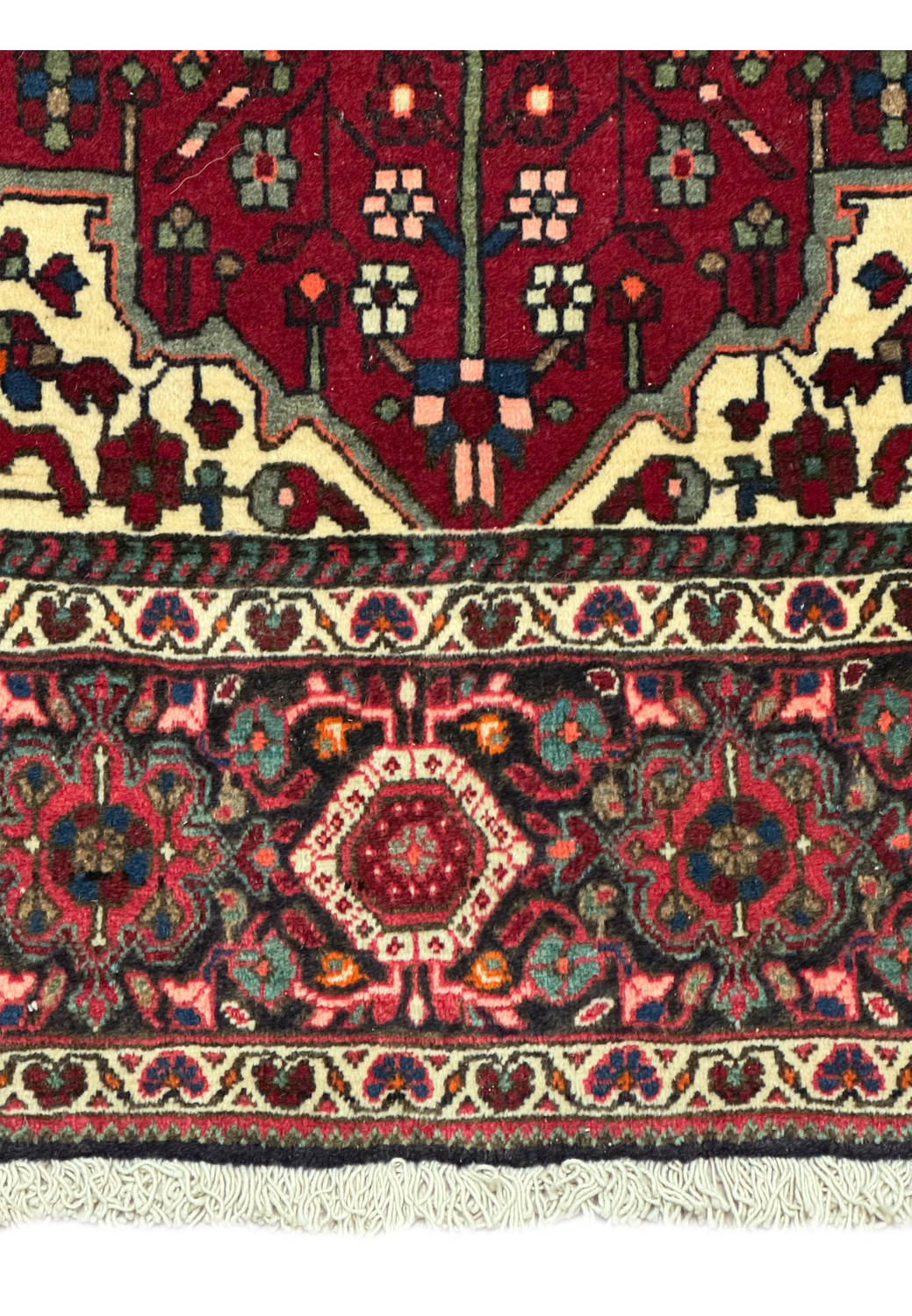 Close-up of the central medallion on the Persian Qum Kork rug, showing the intricate weaving and vibrant color contrasts