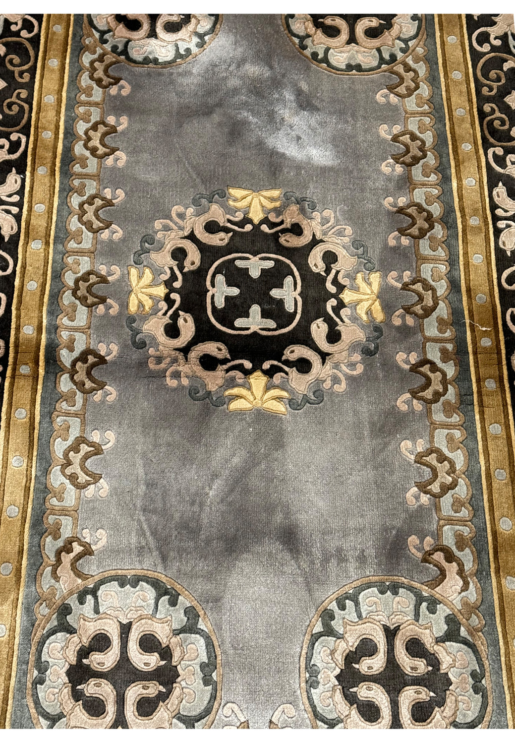 Close-up of the central medallion on Art Deco rug showing the detailed silk accents and plush wool texture