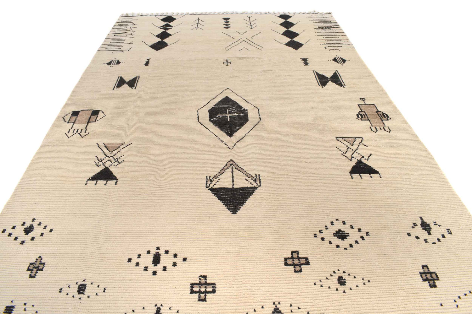 This image provides a full view of the Moroccan rug spread out on the floor. The rug's expansive size is evident, capable of anchoring a large room's furniture arrangement. The patterns are symmetrically distributed across the rug's surface, with smaller motifs filling the spaces between larger, more intricate designs. The texture of the rug is visible, suggesting a thick pile and a soft underfoot feel. The color contrast and pattern symmetry make this rug an eye-catching element in any space.