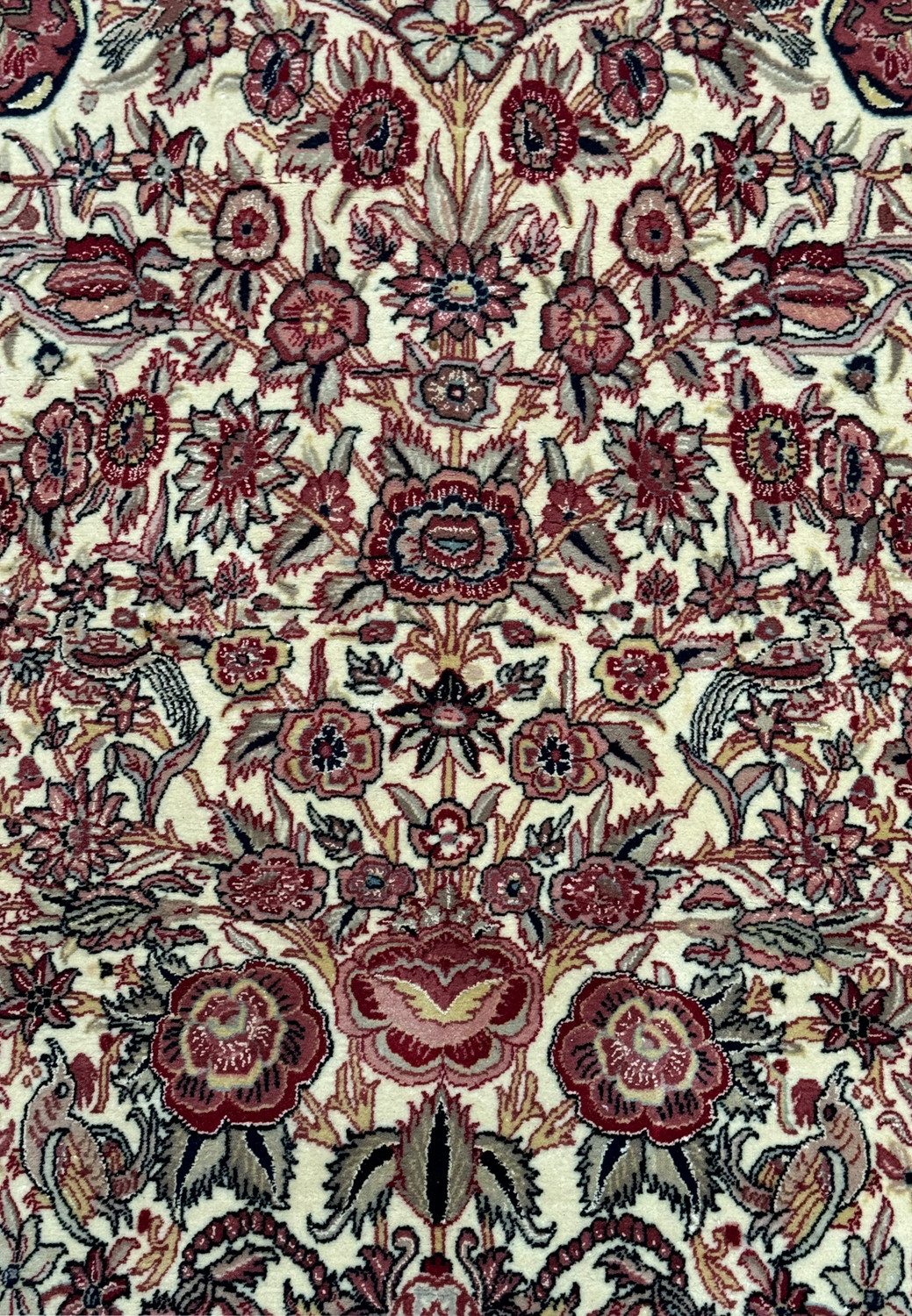 High-resolution close-up of the Persian Qum rug's central design, with a focus on the clarity of the patterns and the vibrant hues of the dyes used in the weaving process.