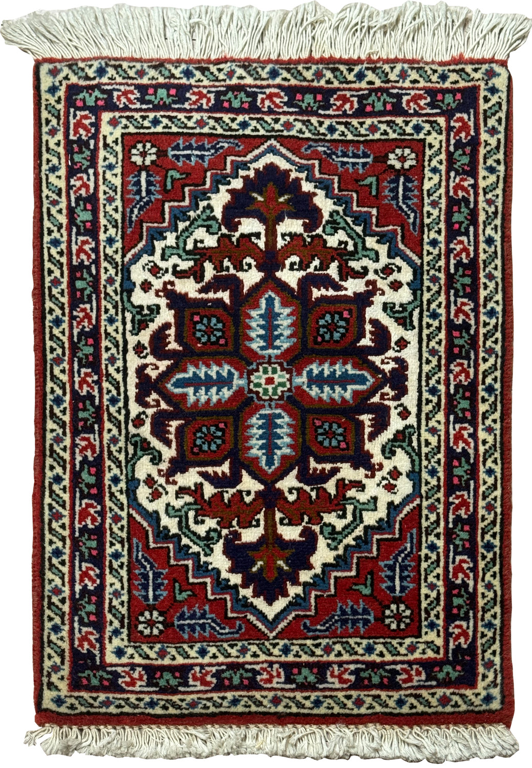 A full view of a Persian Tabriz wool and silk rug, displayed flat, showcasing its central medallion design and intricate patterns in vibrant colors of indigo, crimson, and green with a white fringe