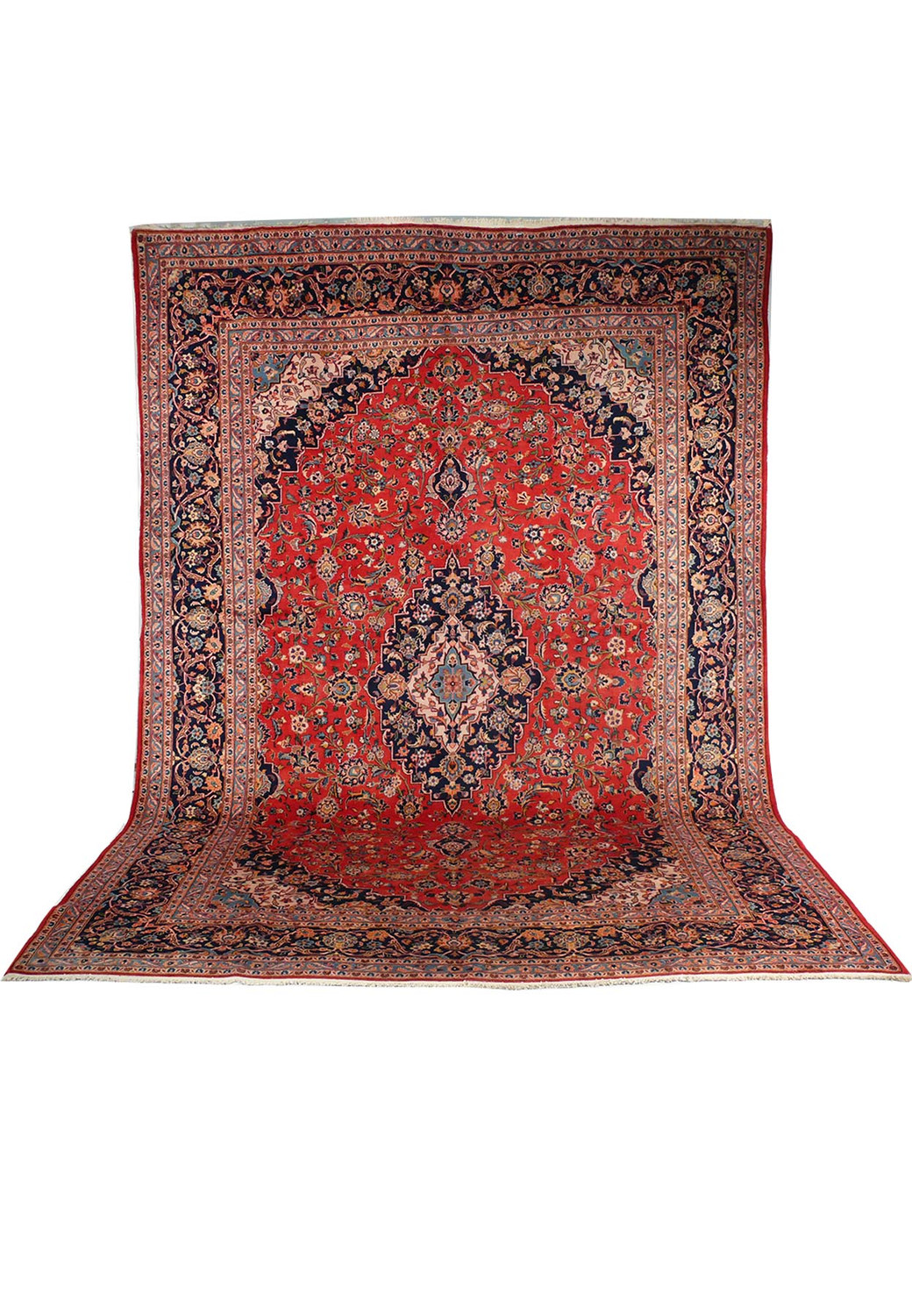 A perspective view of the Persian Kashan rug giving it a three-dimensional appearance, emphasizing the depth of the rich red color and detailed patterns, with the edges curving upwards.