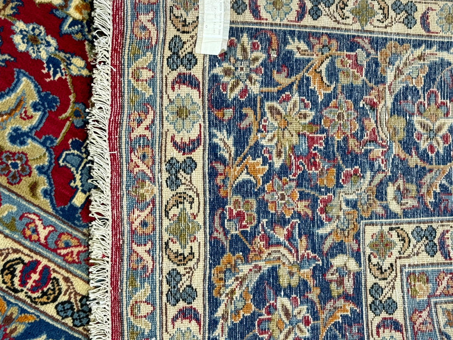 Detailed view of the backside of the Persian Isfahan rug, with the woven structure prominently visible, showcasing the tightness of the knots and the rug's handmade craftsmanship.