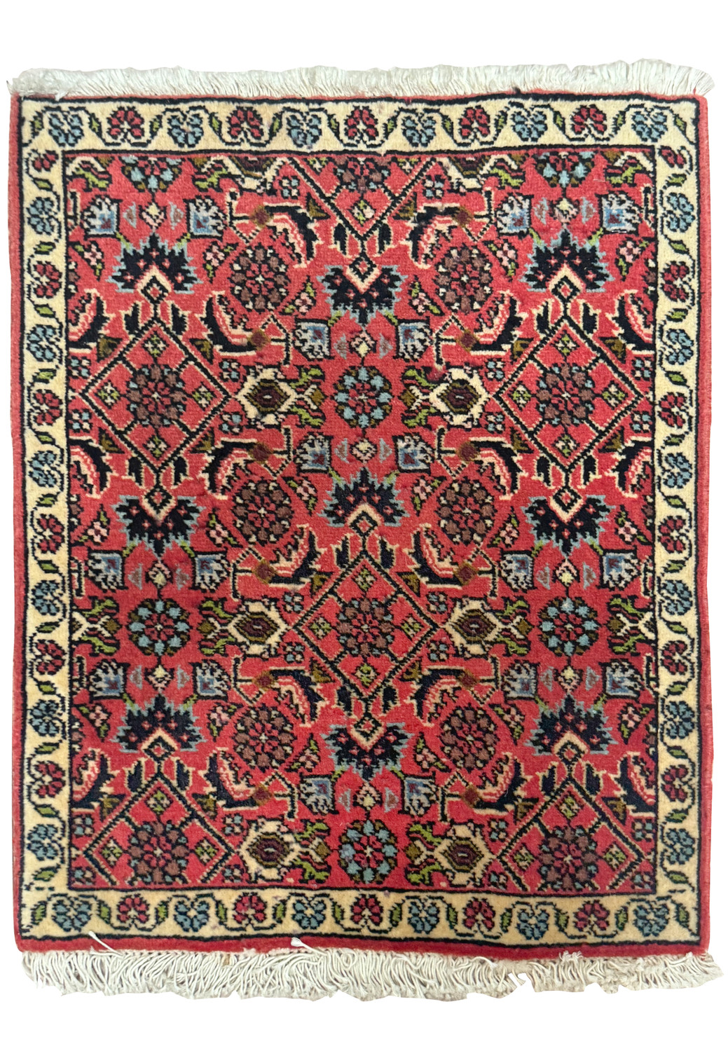 Intricate floral and geometric patterns on a 1'3" x 2' Persian Bijar Baby Rug with a dominant red field and navy blue border, showcasing detailed craftsmanship on a miniature scale.
