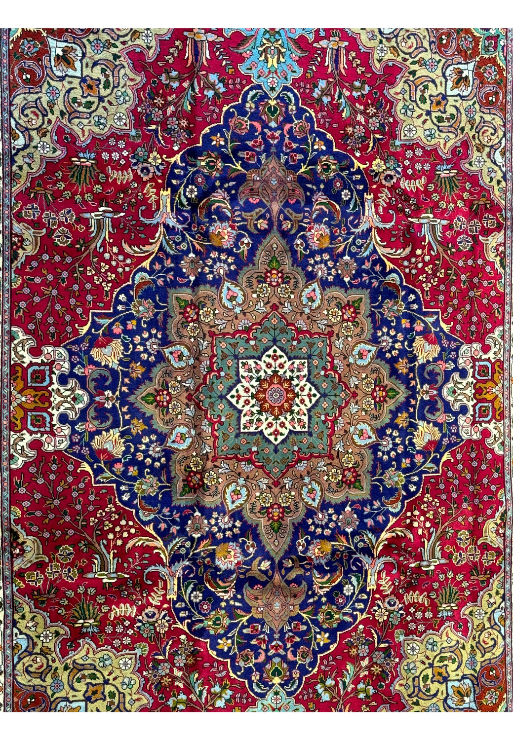 Detail shot of the Persian Geometric Tabriz Rug's border showcasing the fine craftsmanship and array of colors in the smaller medallions and floral designs