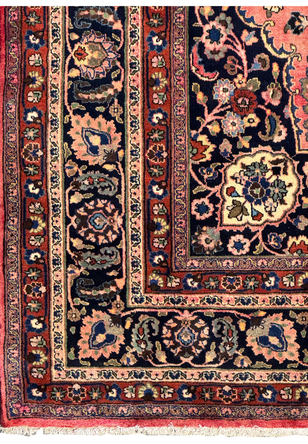 Close-up of the Persian Mashad rug border with detailed patterns and color variation