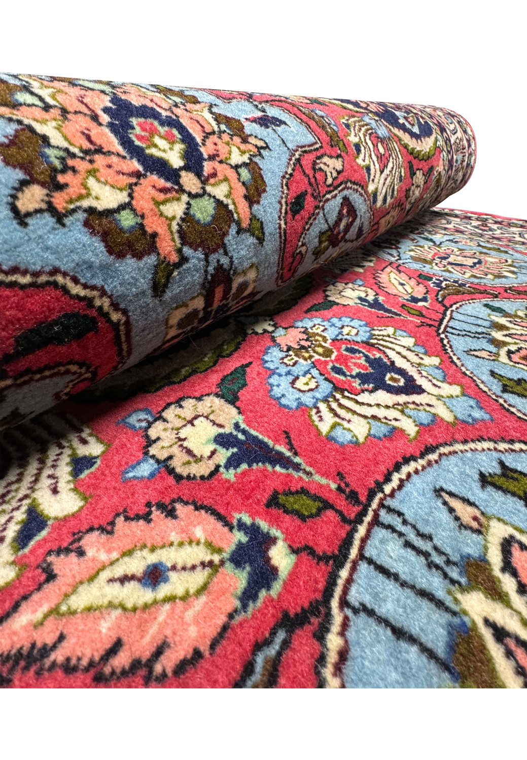 Side view of a rolled 3'7" x 5'2" Persian Bijar rug, exhibiting the thickness and tight weaving that contribute to its reputation as the 'Iron Rug of Persia