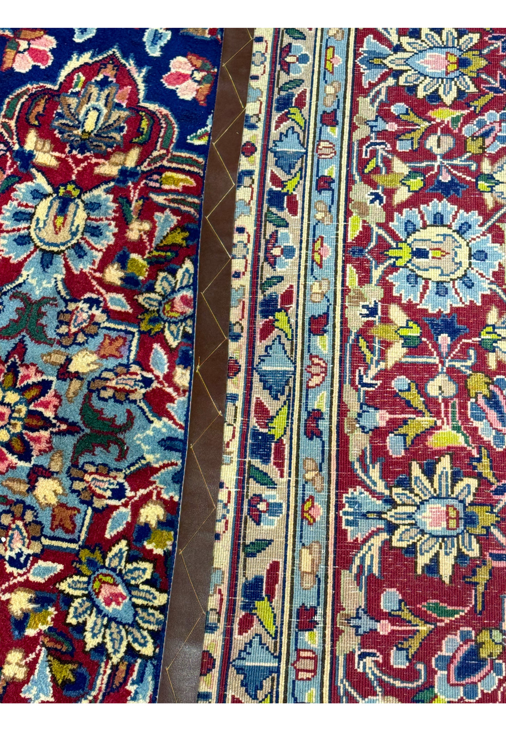 Close-up of the back side of a Persian Kerman Rug with a coin placed for scale, illustrating the fine knotting and weaving quality typical of Kerman rugs