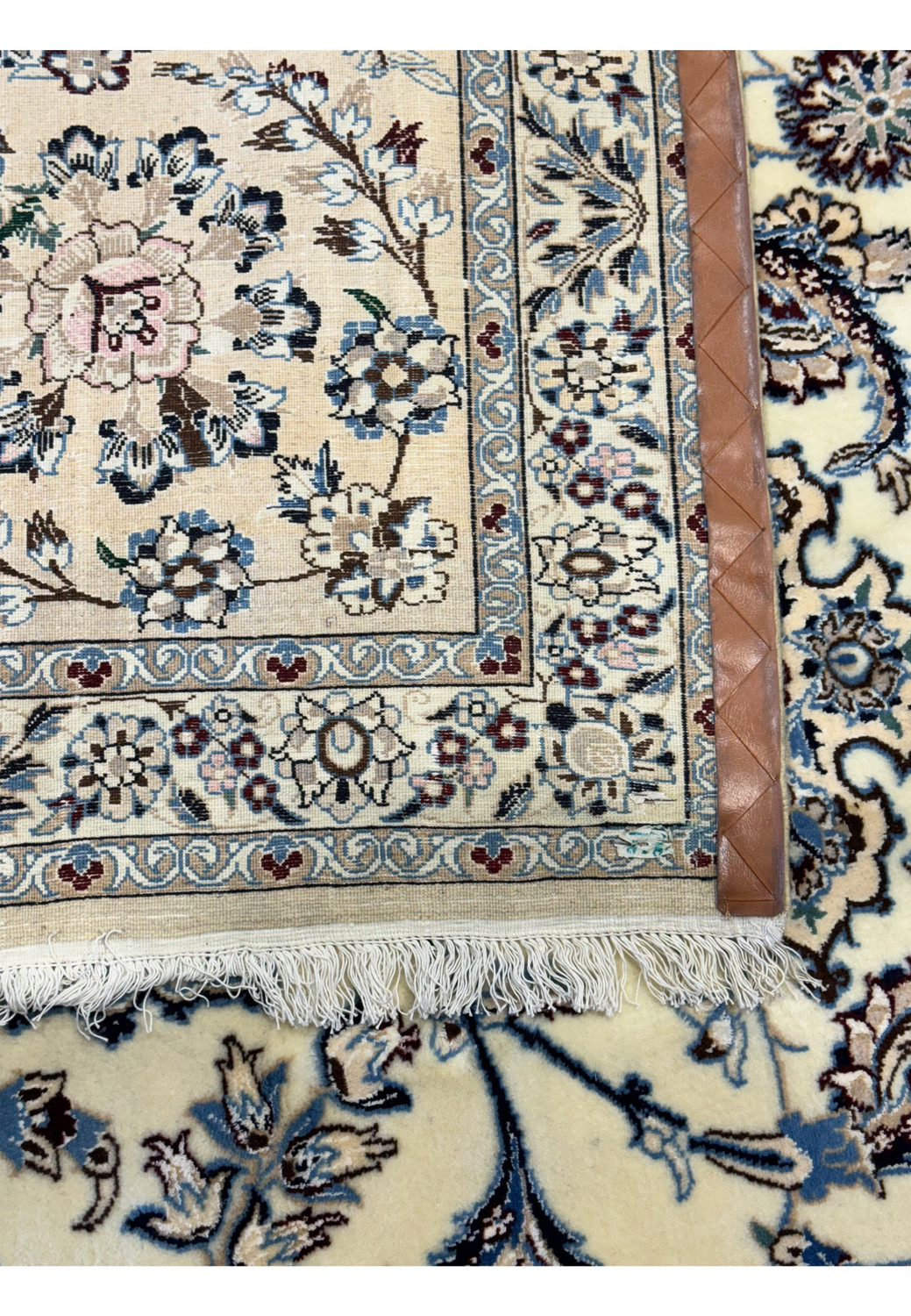 Backside corner view of the Persian Nain 9LAA Wool & Silk Rug with visible leather reinforcement.