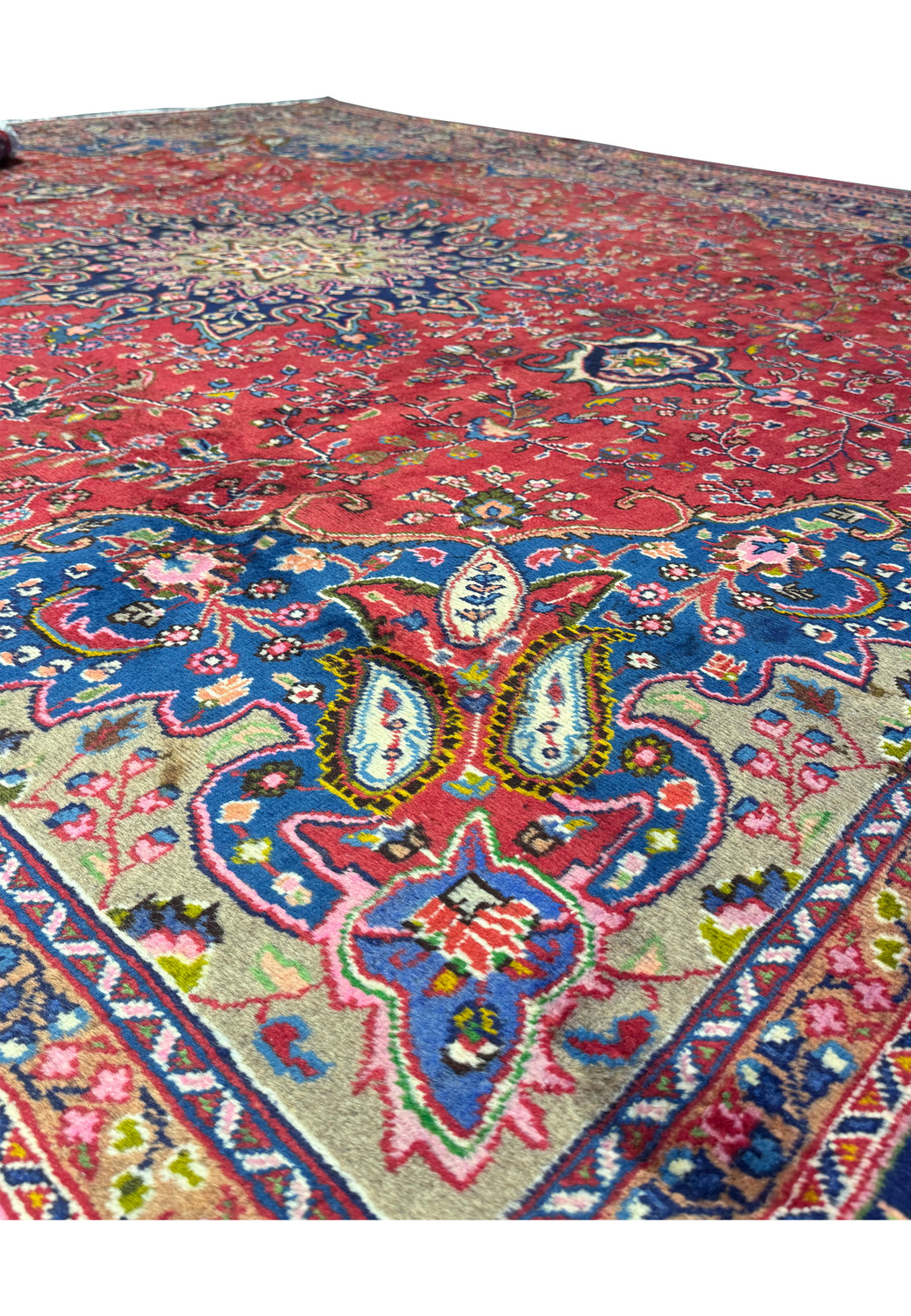 Detailed view of the floral motifs on the 10x12'5 Persian Mashad rug, highlighting the vibrant colors and intricate designs.