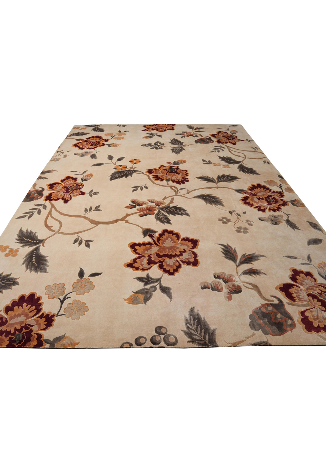 Angled shot of full 9x12 ivory Tibetan rug with bold floral design