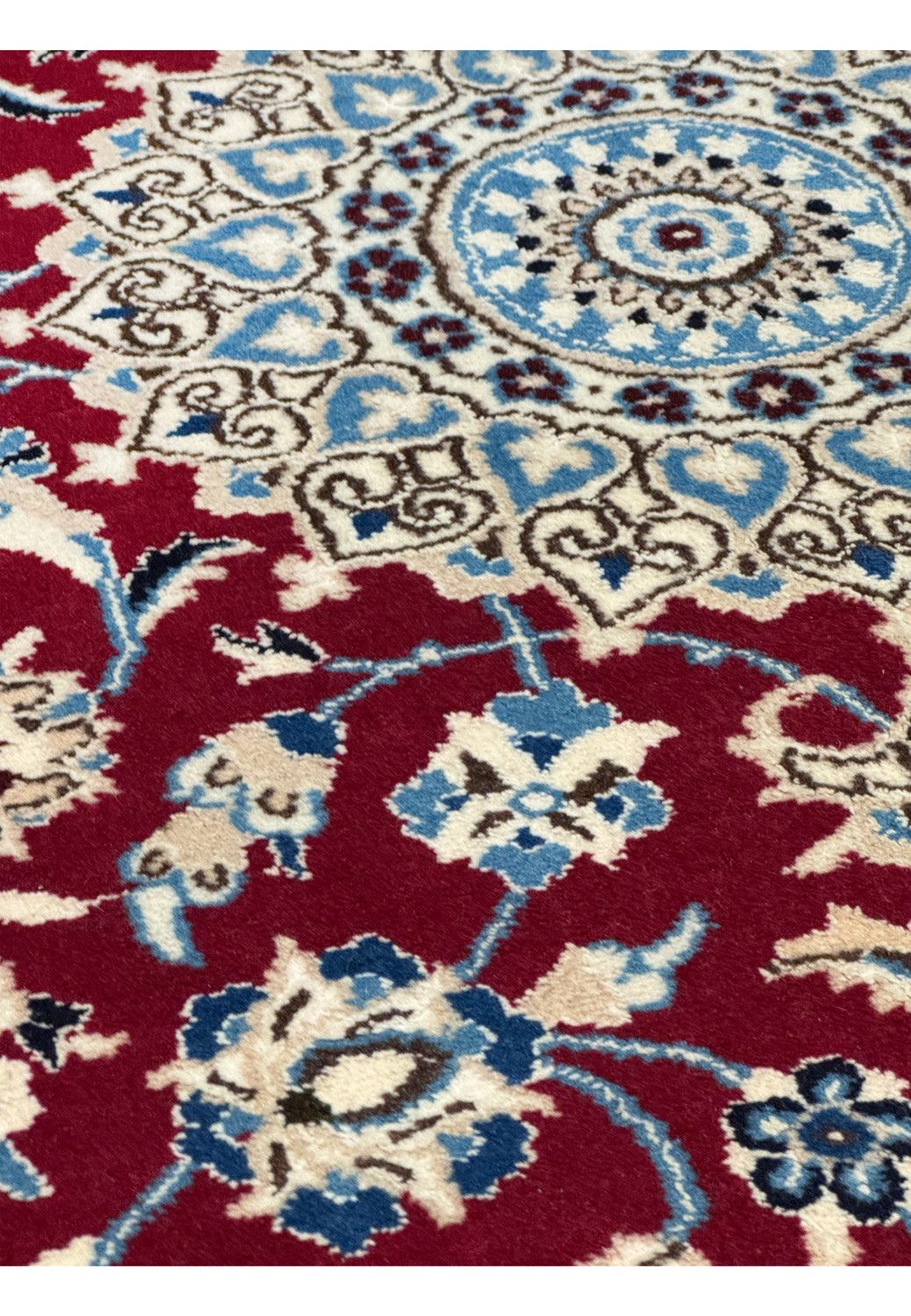 Detailed floral pattern on Persian Nain rug with silk highlights