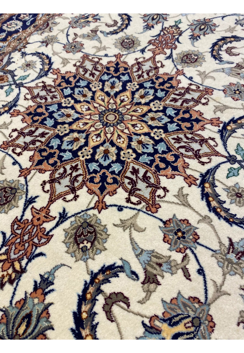 Central field of Persian Isfahan runner with ivory background, navy medallion, and flowing floral arabesques. Central field of Persian Isfahan runner with ivory background, navy medallion, and flowing floral arabesques.