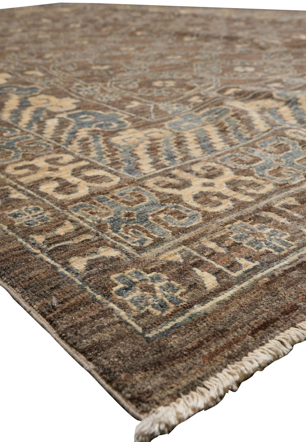 Zigler Transitional Rug edge with beige fringe, brown and grey wool background, and geometric transitional patterns.