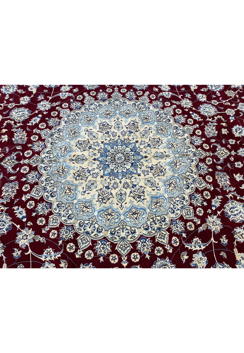 Red field with ivory medallion and surrounding floral arabesques on Persian Nain 9 LAA rug