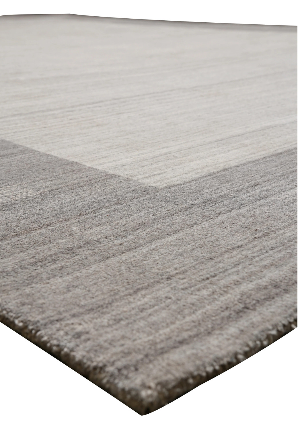Contemporary solid gray wool rug angled view with subtle tonal variations