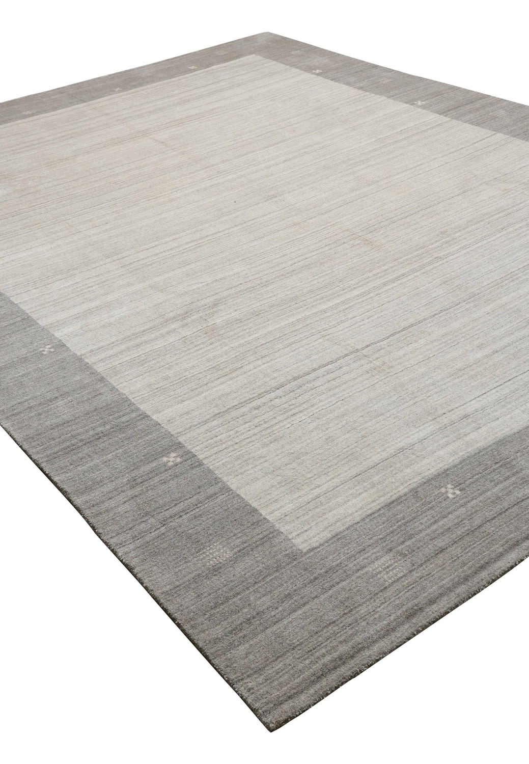 Contemporary solid gray wool rug angled view with subtle tonal variations