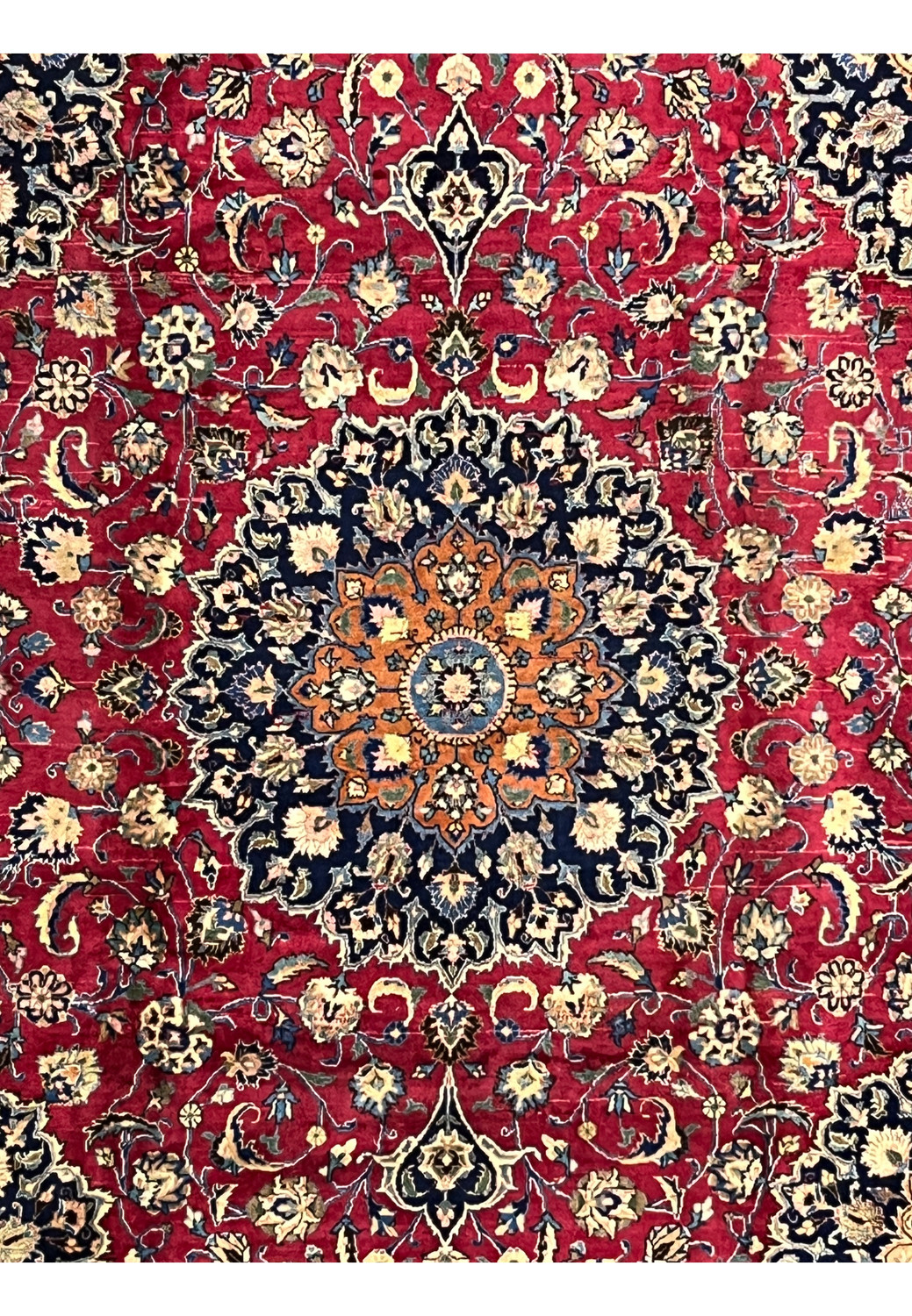Close-up of central medallion with navy, gold, and ivory detailing on Mashad Rug