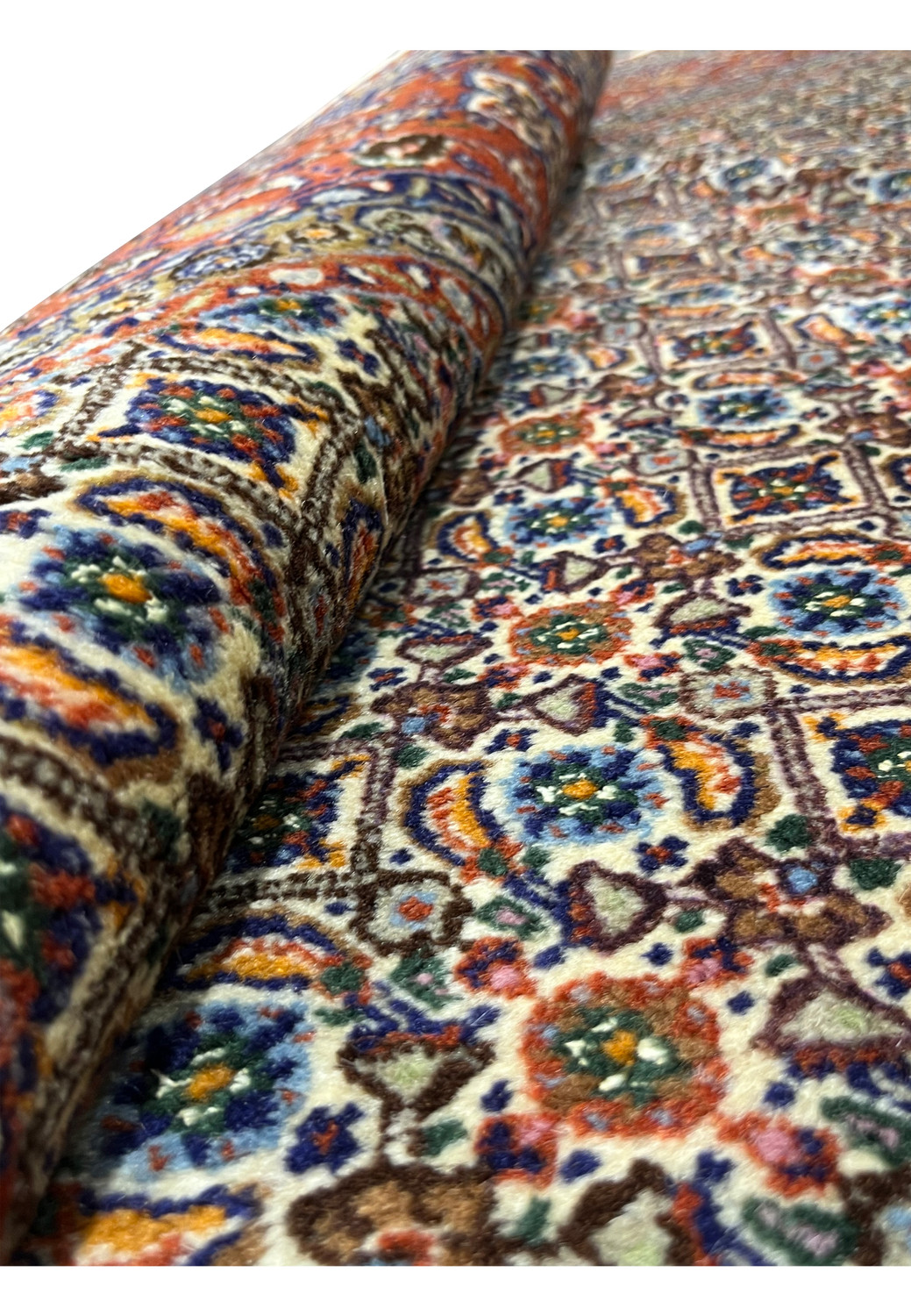Rolled section of rug highlighting wool pile texture and all-over design clarity.