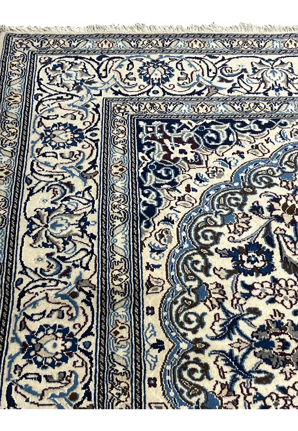 Upper edge view of Square Persian Nain Rug with ivory and navy border pattern