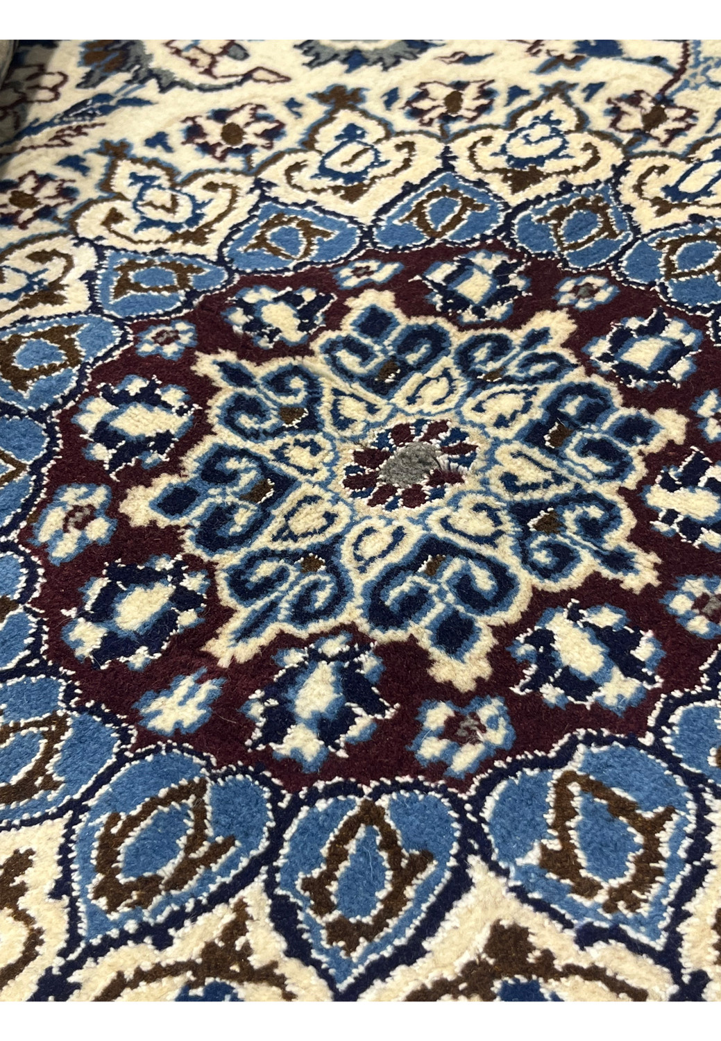 Close-up detail of Square Persian Nain Rug medallion with ivory, sky blue, navy, and burgundy silk highlights