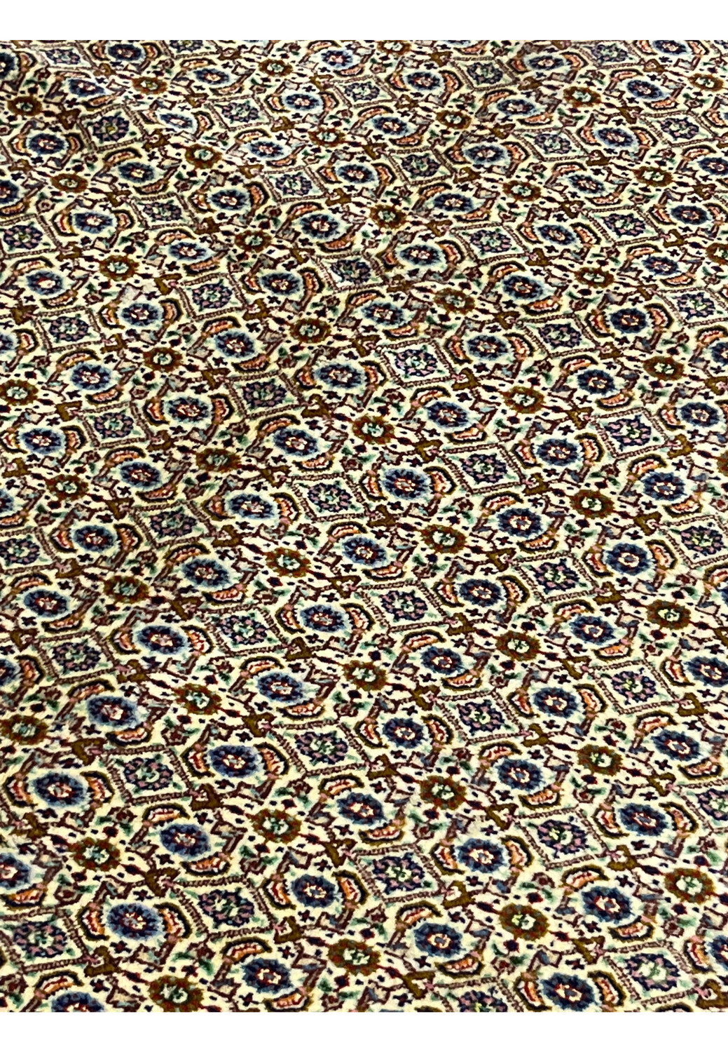Midfield of Persian Moud rug showing repeating Herati motifs in ivory and navy