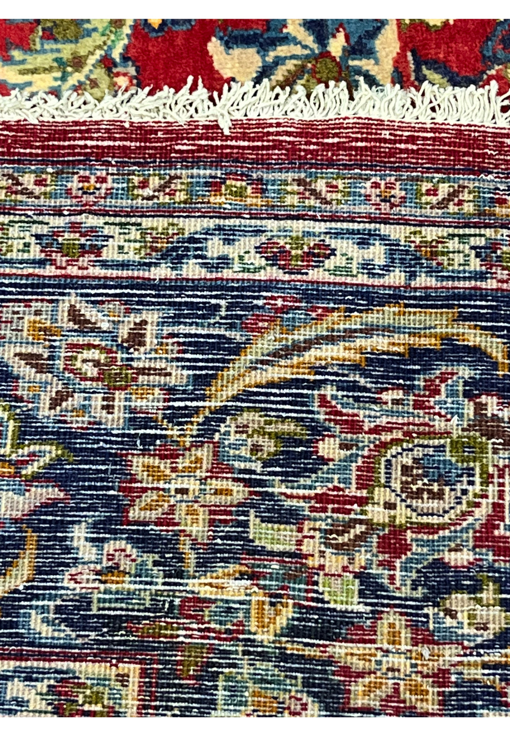 Backside close-up of 9'6 x 12 Persian Isfahan rug revealing fine hand-knotted weave, tight knot density, and rich color contrast of wool fibers.