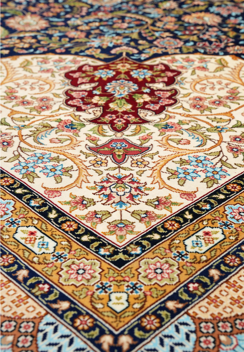 Angled perspective showing the sheen of silk threads and depth of color across the intricate floral design.