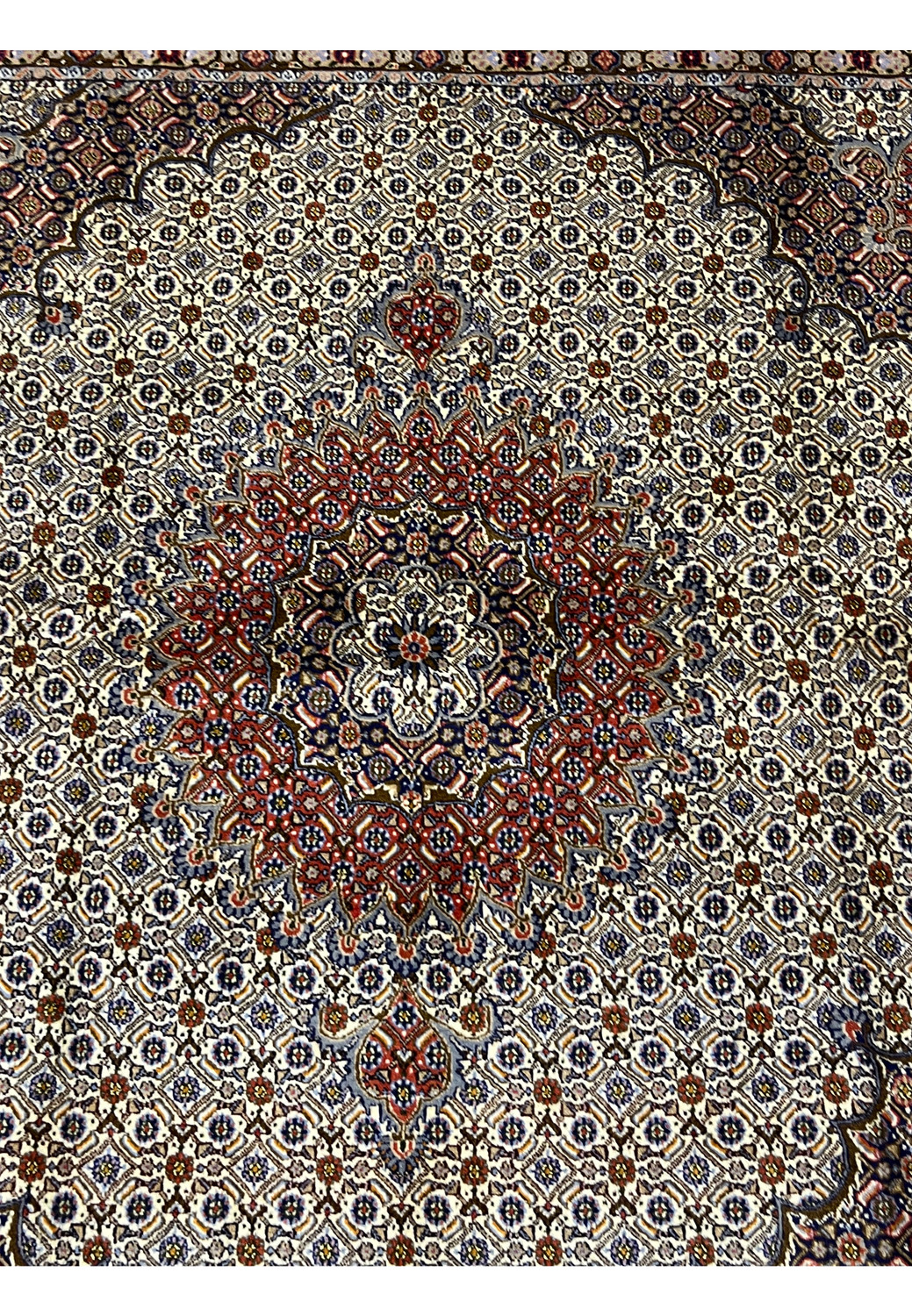 Detailed midfield shot of the Persian Moud Rug focusing on its intricate Herati pattern and the soft contrast between ivory, blue, and red tones with perfect knot alignment.