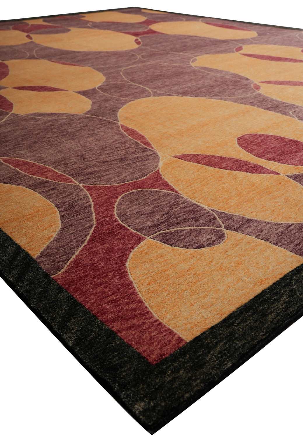 Angled view emphasizing the texture and sheen of the 8.2 x 10 Tibetan Rug, showing circular amber and red forms floating on a plum background bordered in deep charcoal gray.
